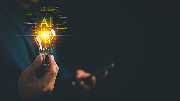 istock A glowing light bulb held in hand with AI brain circuitry. AI in education learning innovation, artificial intelligence, thinking, machine learning, and digital technology in a futuristic concept. 2251369467