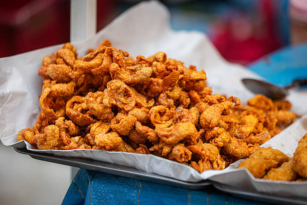 istock Deep fried chicken legs on market stall. 2251371896
