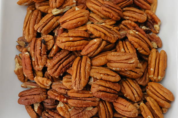 istock Pecan nuts on a plate, close-up shot. 2251372284