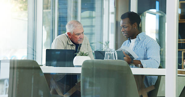 istock Business men, meeting and planning with documents for brand proposal, idea or training. Paperwork, discussion and team in office for campaign mentorship, coaching and help with project strategy 2251373454