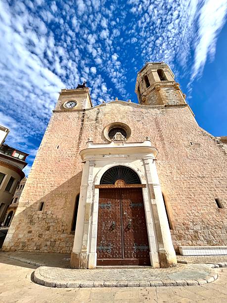 istock Sant Bartomeu i Santa Tecla Church with cumulus clouds in Sitges 2251374113