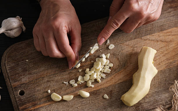 istock Woman Slicing Garlic 2251375501