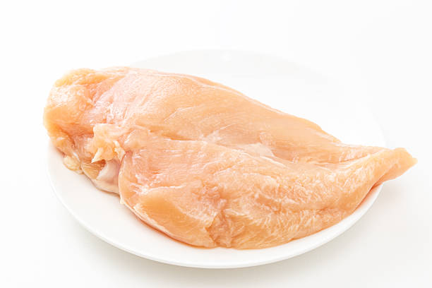 chicken fillet on a chopping board isolated on white