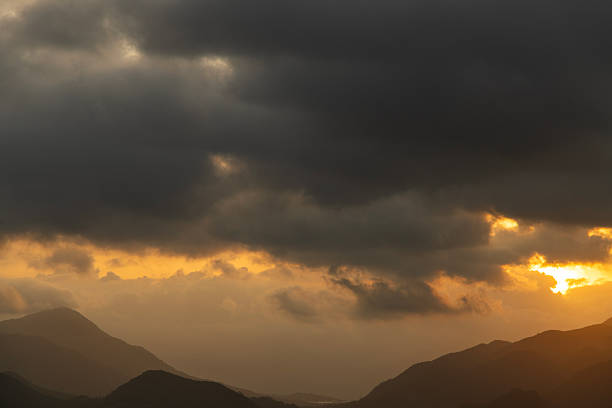 Bright sunset over the silhouette mountains at evening time.Bright sunset over the silhouette mountains at evening time.