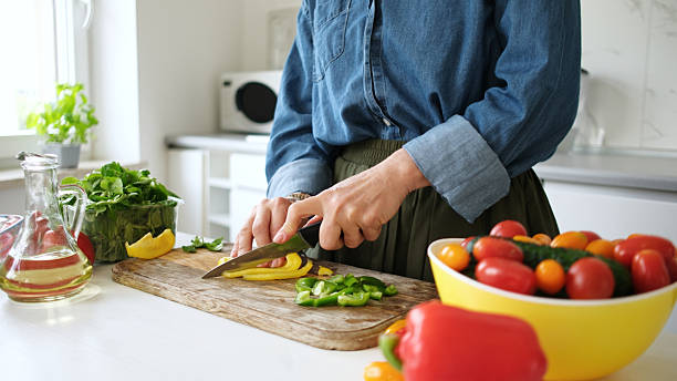 istock Woman Slicing Yellow Pepper 2251377970