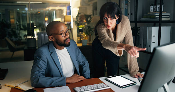 istock Business, people and explain with computer at night for training, finance report and budget. Staff, pc and coaching for audit procedure, financial evaluation and working late for investment deadline 2251378660