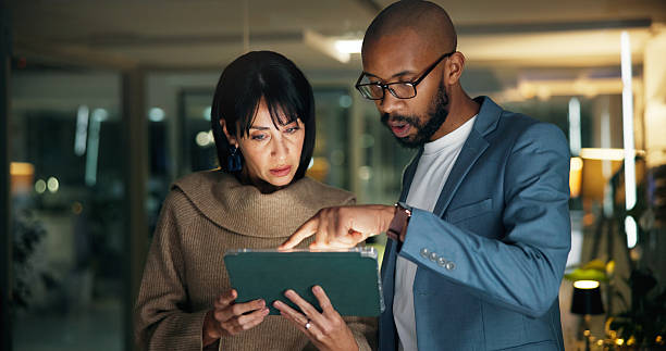 istock Tablet, planning and business people in office for report, collaboration and feedback. Technology, drafting proposal and research with team for proofreading, review and editing publication at night 2251378698