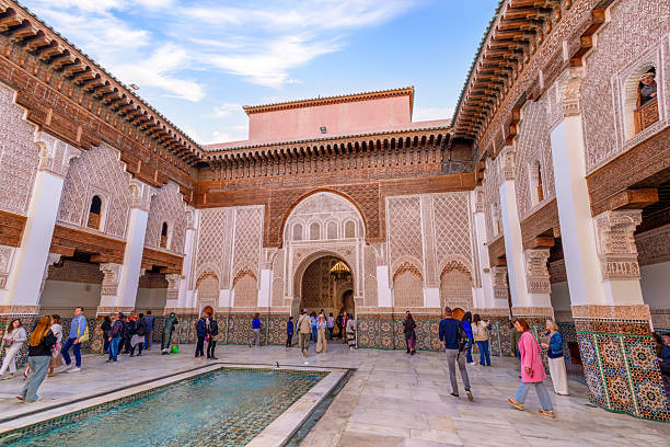 Tourists visit the Mosque and University of al-Qarawiyyin in the old town Medina of Fez el Bali, Fez, Morocco