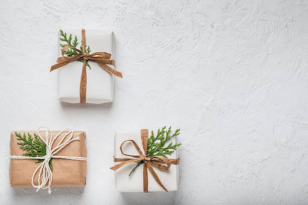 istock Three gift boxes on a white background and thuja branches. Concept of Christmas holidays and gifts. Postcard, layout. Boxing Day. 2251379911
