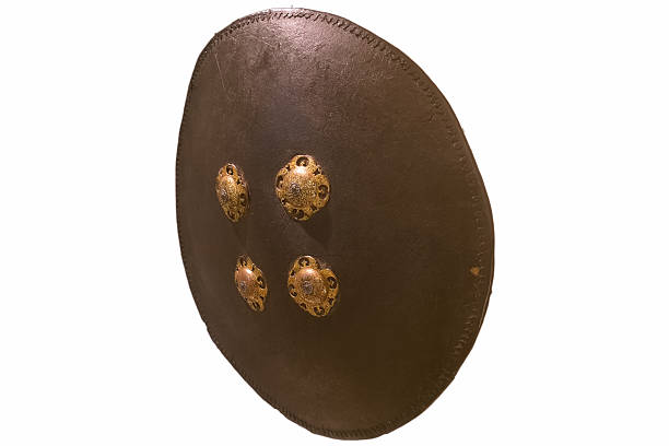 Digital security concept. Data protection technology. Golden shield icon on dark background. Minimalistic setup with copy space. Elements painted with dark graphite metallic paint.