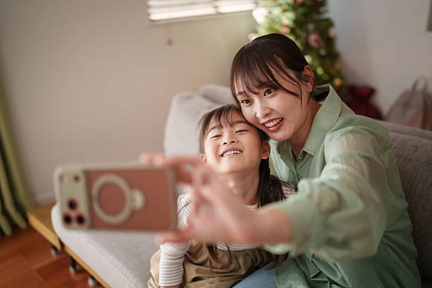 istock Happy mother and child using smartphone together at home 2251386567