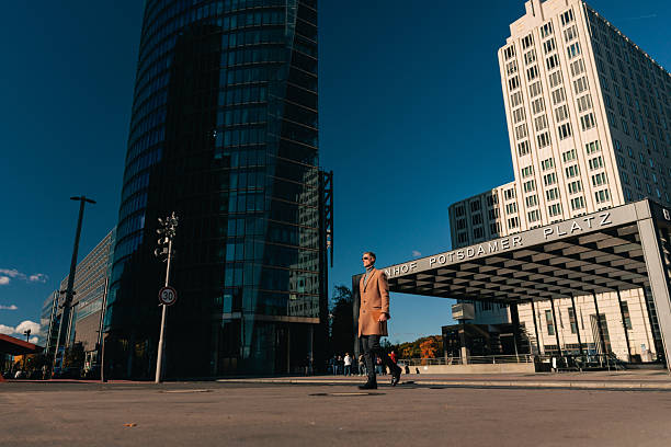 People doing normal activity on the crowded streets of Neukolln, Berlin as the summer sun shines.