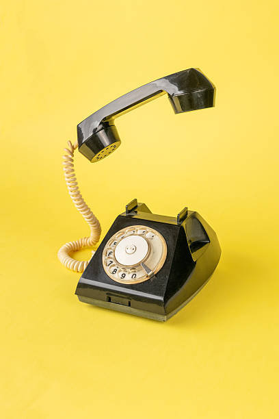 istock Vintage Rotary Telephone on Bright Yellow Background 2251390793