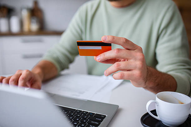 istock Man Confirms Digital Payment While Holding Credit Card 2251394941