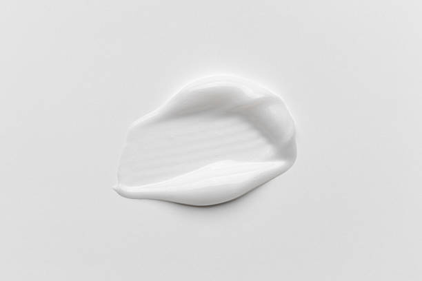 istock cream stroke isolated on white background. White cream smear smudge sample. face or body skincare product swatch. showcase of the product 2251395010