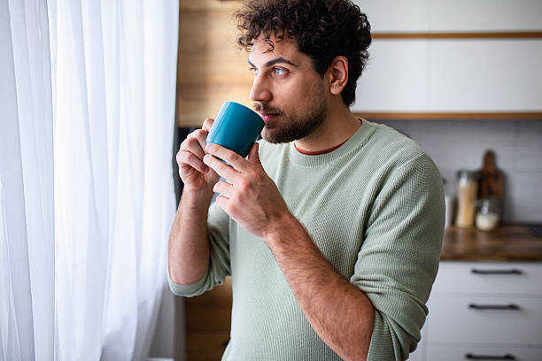 istock Man Drinking Morning Coffee in the Kitchen 2251395939