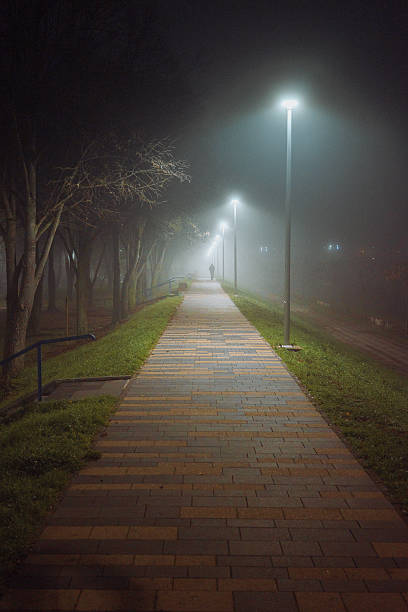 istock A foggy walkway with a man in the distance 2251398024