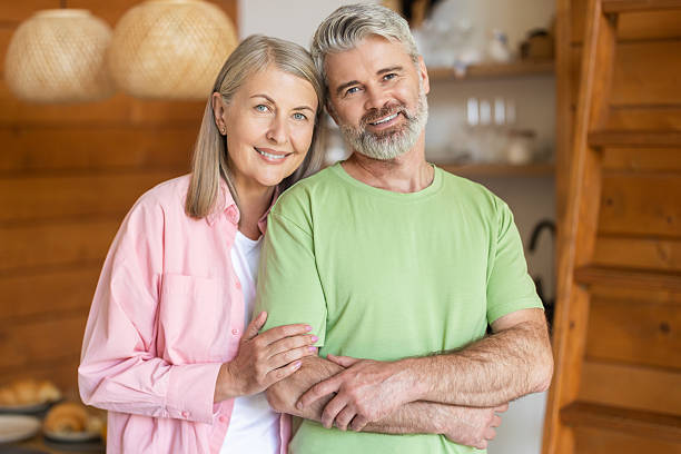 istock Senior couple smiling while posing for portrait in home interior 2251398647