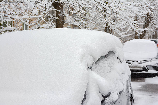 istock Heavy snowfall covered cars. Winter cityscape 2251402326