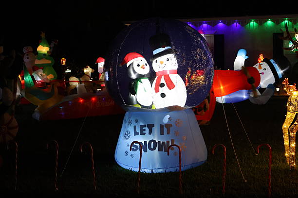 Christmas decoration featuring a glowing Let It Snow snowman globe scene in Florida.