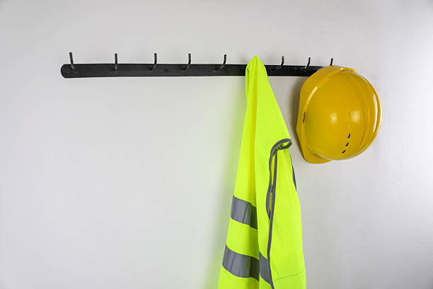 istock Hard Hat And Safety Vest On Hooks 2251405022
