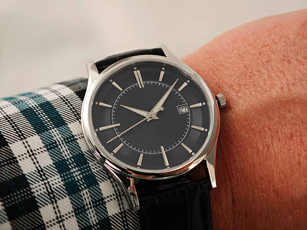 istock Luxury Men’s Watch with Black Leather Strap – Business Class Elegance. Elegant analog wristwatch with a polished silver case, deep black dial, and fine black leather strap 2251412780