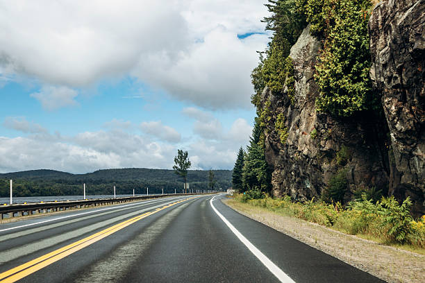 Scenic highway through dense green forest near La Tuque, Quebec