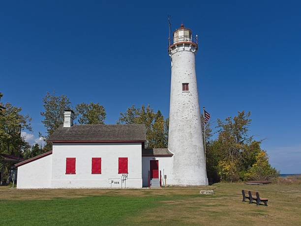 Alcona Michigan - USA, October 6, 2025. Sturgeon Point lighthouse, a painted white brick structure with red storm shutters. Sturgeon Point Lighthouse dates from 1870 protects the northeastern Michigan lake Huron coast.