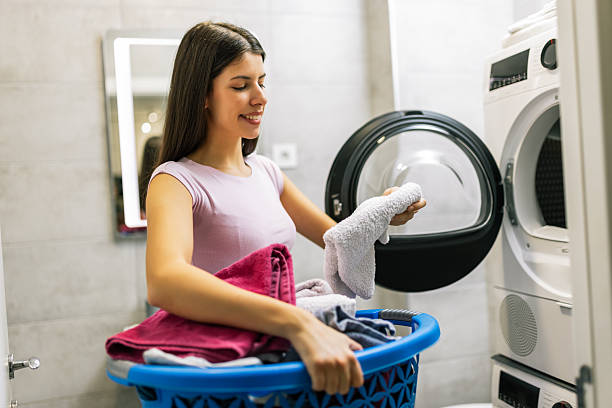 istock Woman Taking Clean Towels from Washing Machine 2251414686