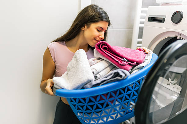 istock Woman Smelling Clean Towels 2251414748