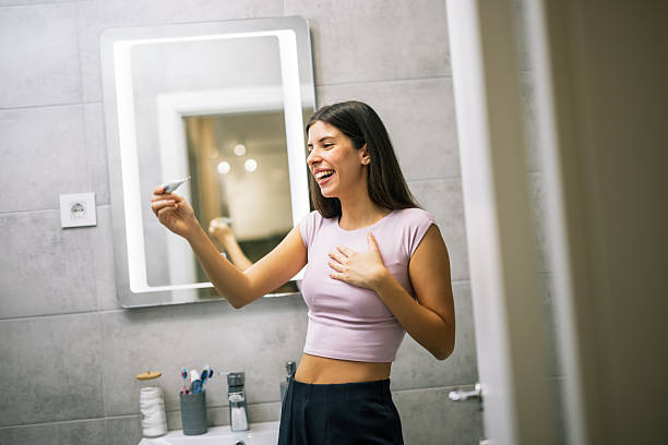 istock Woman Holding Pregnancy Test with Happiness 2251414977