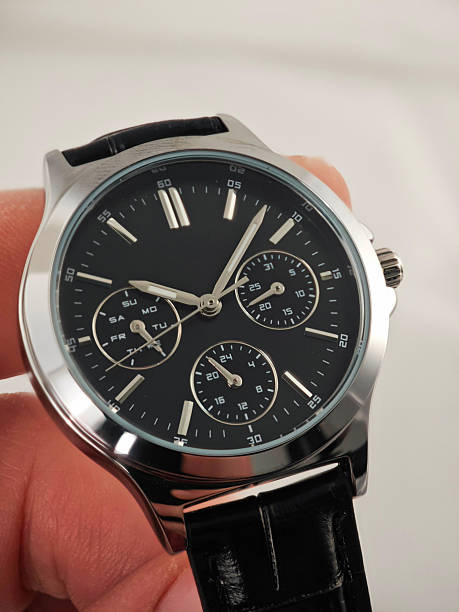 istock Luxury Men’s Watch with Black Leather Strap – Business Class Elegance. Elegant analog wristwatch with a polished silver case, deep black dial, and fine black leather strap 2251414982