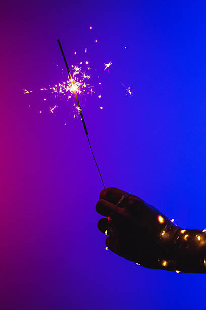 istock Sparkler in hand. Neon light. Hand in garland 2251415021