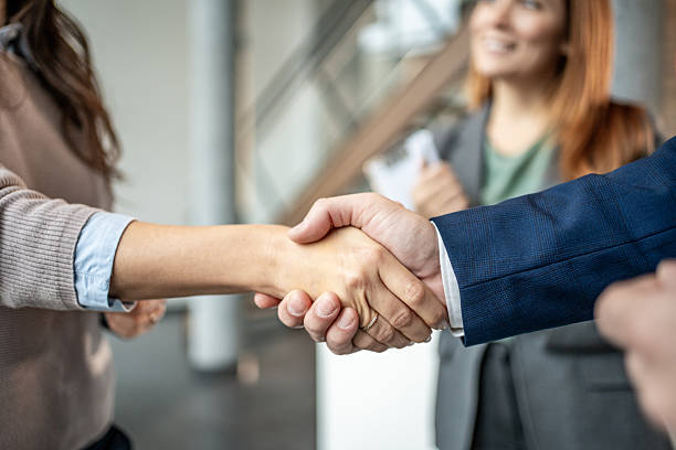 istock Business colleagues shaking hands making agreement at office 2251418050