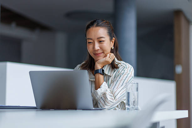 istock Professional woman working remotely on laptop at office 2251420156