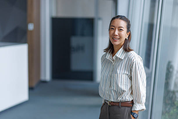 istock Asian businesswoman smiling in modern an office setting 2251420170