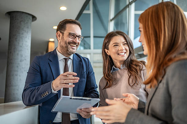 istock Business people smiling having a discussion in modern office 2251421067