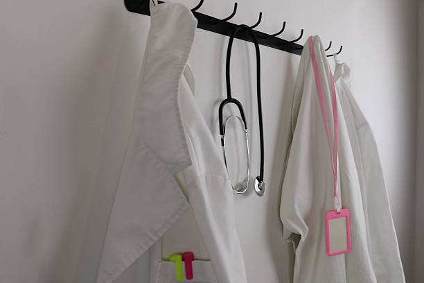 istock Hospital Lab Coats With Stethoscope And ID Badge 2251421105