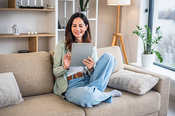 istock Woman relaxing at home using digital tablet 2251422023