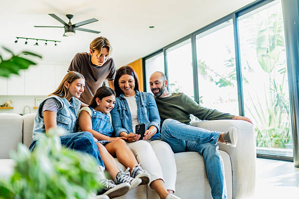 istock Family talking and using mobile phone at home 2251423009