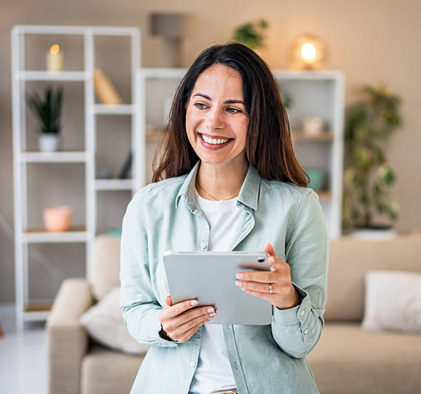 istock Happy woman using digital tablet enjoying leisure at home 2251423174