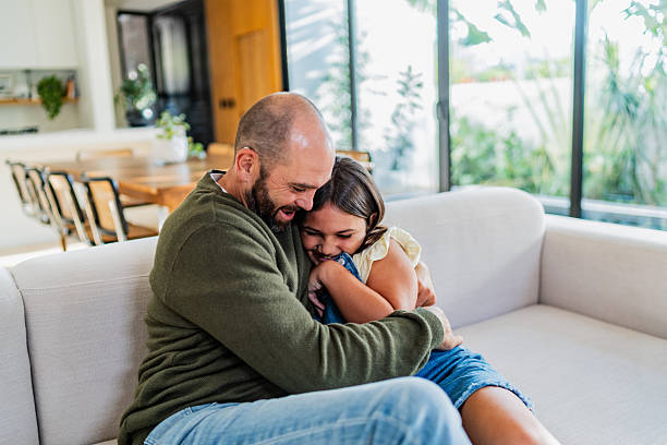 istock Father and daughter embraced at home 2251423259