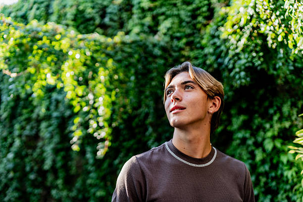 istock Young man looking away contemplating outdoors 2251423270