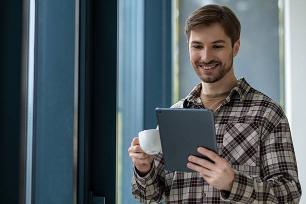 istock Young man in plaid shirt looking confident and smiling nicely 2251423644