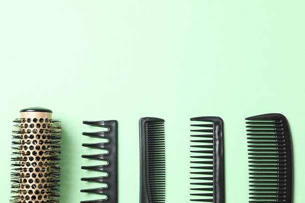 istock Professional combs and hairdresser tools on color background, top view 2251425748