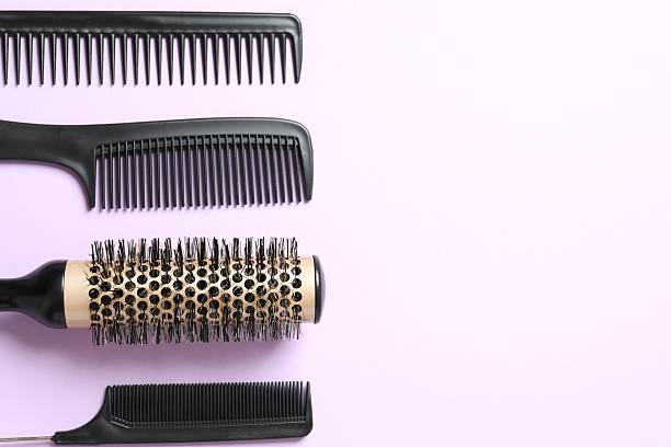istock Professional combs and hairdresser tools on color background, top view 2251425749