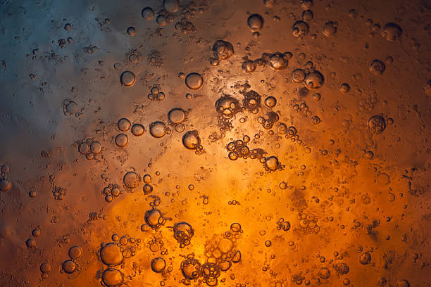 istock Ice texture. Frozen bubbles in ice. Orange dark grunge abstraction 2251429127
