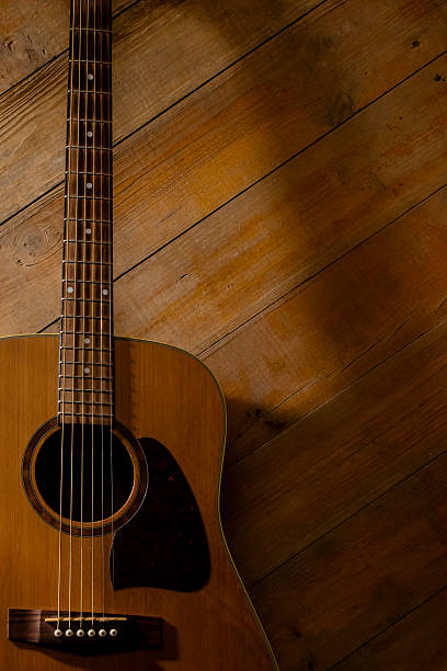 istock Acoustic guitar on a wooden background with space for copy 2251430987