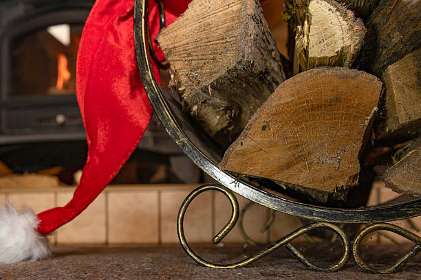 istock Firewood basket with Santa hat creating festive rustic holiday mood 2251432260