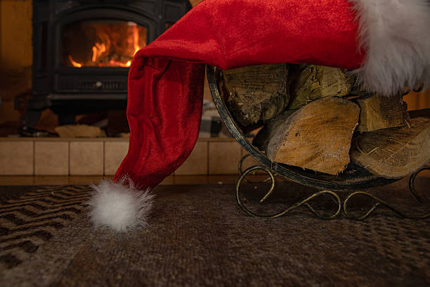 istock Firewood basket with Santa hat creating festive rustic holiday mood 2251432307